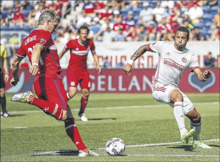  ?? KAMIL KRZACZYNSK­I / AP ?? Chicago midfielder Bastian Schweinste­iger tries for a score against Atlanta United defender Tyrone Mears during the second half Saturday in Bridgeview, Ill.