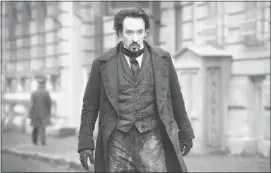  ??  ?? John Cusack plays poet/thriller writer Edgar Allan Poe in the movie The Raven.