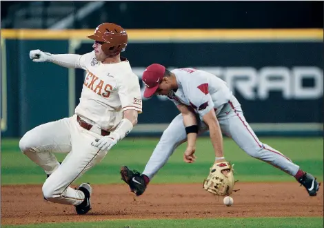  ?? (Special to the Arkansas Democrat-Gazette/Chris Daigle) ?? Arkansas second baseman Robert Moore misplays a ground ball in the Razorbacks’ loss to Texas on Saturday night in Houston. The Razorbacks committed a total of seven errors in their three losses over the weekend in the Shriners College Classic.