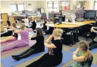  ??  ?? Staff at HealthCare 21 take part in a pilates class during their lunch break