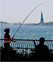  ?? AP FILE PHOTO ?? A man fishes from the Battery City Park esplanade last summer as temperatur­es near 90 degrees in New York. The weather in New York City in a few decades will feel like how Arkansas is now if global warming pollution continues at its current pace, a study finds.