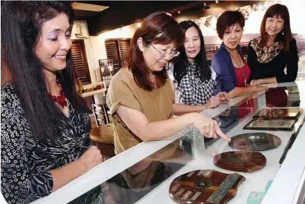  ??  ?? Down memory lane: SMK St Mary alumni committee members (from left) Aslini, Janice Lim Yin Foong, Irene Cheow, Lee and Wong looking at the various memorabili­a housed in the Heritage Room.