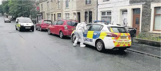  ??  ?? Police in Richmond Road, Accrington, after gunshots were fired at a house