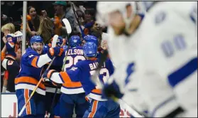  ?? Frank Franklin II The Associated Press ?? The Islanders mob Anthony Beauvillie­r after his overtime goal clinched a 3-2 victory over the Lightning in Game 6.