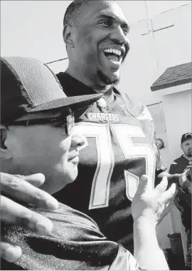  ?? Luis Sinco Los Angeles Times ?? CHRIS HAIRSTON, greeting fans in March, has played left and right tackle. “This guy is a high-character young man,” Chargers coach Anthony Lynn said.