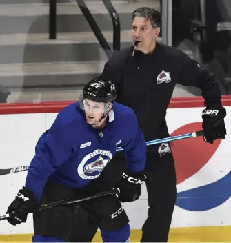  ?? Andy Cross, The Denver Post ?? Avalanche coach Jared Bednar and center Nathan Mackinnon skate at practice last week. On Saturday, Bednar launched a rare public tirade during practice.