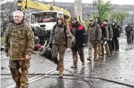  ?? RUSSIAN DEFENSE MINISTRY PRESS SERVICE VIA AP ?? This photo taken from video released by the Russian Defense Ministry on Thursday shows Ukrainian servicemen as they leave the besieged Azovstal steel plant in Mariupol, in territory under the government of the Donetsk People’s Republic, eastern Ukraine.