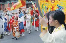  ?? — Reuters ?? Worshipper­s dressed in costumes react during a religion parade against the government’s policy to cut down paper burnings in an attempt to improve air quality, in Taipei on Sunday.