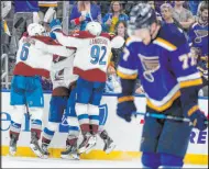  ?? Jeff Roberson The Associated Press ?? The Avalanche celebrate center Darren Helm’s go-ahead goal behind Blues defenseman Niko Mikkola with 5.6 seconds left in Colorado’s 3-2 victory Friday night.