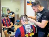  ?? AFP ?? Craze for the Messi hair tattoo has caught on in Serbia.