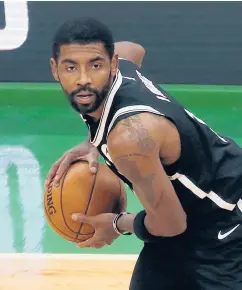  ?? MARY SCHWALM | AP ?? Brooklyn Nets guard Kyrie Irving looks to pass during the first half against the Boston Celtics Dec. 18.