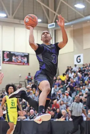  ?? MARK J. REBILAS/USA TODAY SPORTS ?? IMG Academy forward Bryson Tucker goes to the basket against Arizona Compass Prep during the HoopHall West basketball tournament at Chaparral High School.