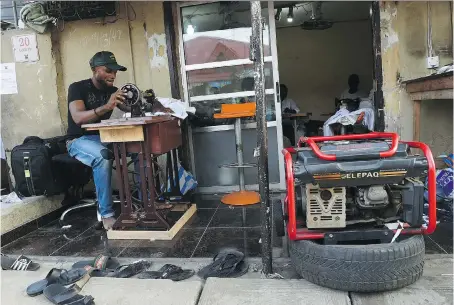  ?? UTOMI EKPEI/GETTY IMAGES ?? Like many Nigerian residents and small business owners, this tailor is forced to use a small generator for power. One entreprene­ur saw this problem as an opportunit­y and started a company that leases hybrid solar batteries.