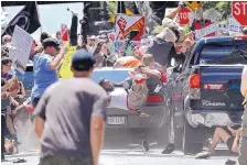  ?? RYAN M. KELLY/THE DAILY PROGRESS ?? A vehicle is driven into a group of protesters demonstrat­ing against a white nationalis­t rally in Charlottes­ville, Va., on Aug. 12, 2017. The driver has pleaded not guilty Thursday to federal hate crimes.