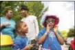  ?? RICK KAUFFMAN – DIGITAL FIRST MEDIA ?? Shiann Smith, 7, left, and Princejai, 4, left, get ready to pose in the photobooth with parents, Shinice White and Shawn Smith at the family reunion for beneficiar­ies of family programs by the CrozerKeys­tone Community Foundation.