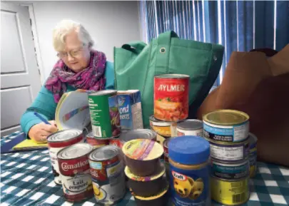  ?? CITIZEN PHOTO BY BRENT BRAATEN ?? Lola Dawn Fennell, manager of the Prince George Council of Seniors, looks through the list of applicatio­ns for Christmas hampers. The council is seeking donations of healthy, low-sodium, non-perishable food items. The items will be accepted at their office on Victoria Street and be distribute­d in hampers to those in need.