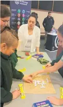  ??  ?? Students playing Hanga Kupu (scrabble).