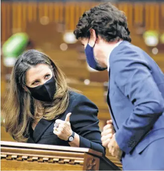  ?? BLAIR GABLE • REUTERS ?? Canada’s Finance Minister Chrystia Freeland gives a thumbs up to Prime Minister Justin Trudeau during the delivery of the federal budget in the House of Commons on Parliament Hill in Ottawa on Monday.