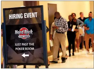  ?? AP ?? Applicants attend a job fair in June in Hollywood, Fla. U.S. job openings declined in July, but there are 1.2 job openings for every unemployed person, according to reports.