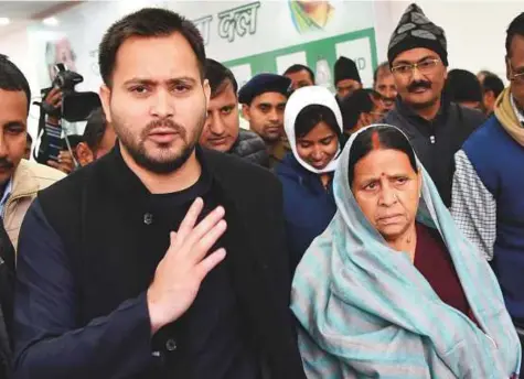  ?? PTI ?? Former Bihar CM and RJD senior leader Rabri Devi, wife of Lalu Prasad, and her son and leader of opposition Tejashwi Yadav after the press conference in Patna yesterday.