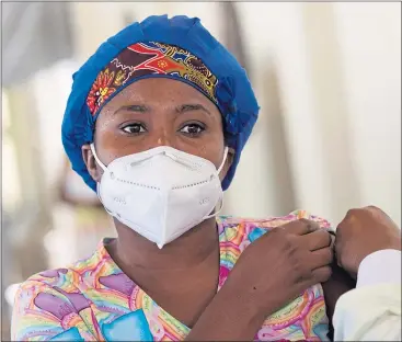  ?? ?? A woman receives her vaccine in Portau-prince, Haiti, in July