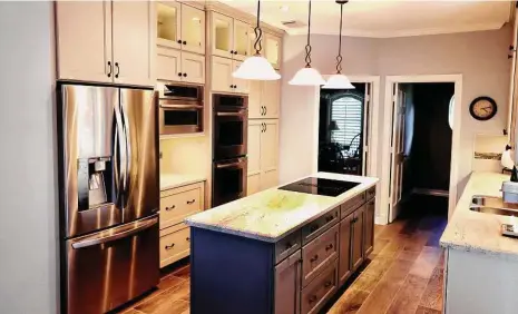  ?? Courtesy of Your Dream Remodeling ?? This kitchen maximizes storage and workspace with built-in appliances and floor-to-ceiling cabinets.