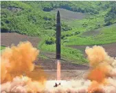  ?? AP ?? North Korea launches an interconti­nental ballistic missile July 4. The regime has threatened to fire missiles near Guam, but experts say the Pentagon would try to shoot them down.