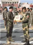  ?? ANI ?? ■ BSP Commandant Jasbir Singh presents sweets to Pakistani Rangers’ Wing Commander Aamir on the 74th Republic Day, at the Attari-Wagah border.