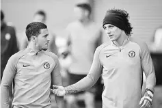  ??  ?? Chelsea’s Belgian midfielder Eden Hazard (left) and Chelsea’s Brazilian defender David Luiz attend a team training session at Chelsea’s Cobham training facility in Stoke D’Abernon, southwest of London on the eve of their UEFA Champions League Group C...