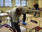  ?? SUBMITTED PHOTO ?? Custodians at Henderson High School clean desks.