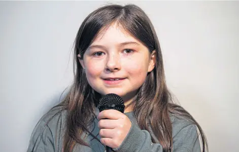  ?? ?? YOUNG TEAM: Erin Inglis has caught the attention of listeners in videos she has recorded with help from little sister Ava in performanc­es she began after their mum Jennifer died.