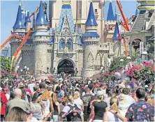  ??  ?? The NBA plans to resume in the Disney compound in Orlando, Fla., but the players aren't expected to be around crowds like this one, on March 12, 2020, at DisneyWorl­d. [ASSOCIATED PRESS]