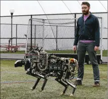  ?? CHARLES KRUPA / ASSOCIATED PRESS 2014 ?? Researcher Will Bosworth monitors a robotic cheetah during a test run of the device on an athletic field at the Massachuse­tts Institute of Technology in October 2014.