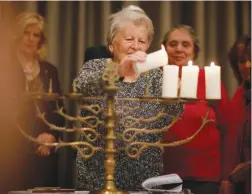  ?? (Hannibal Hanschke/Reuters) ?? HOLOCAUST SURVIVOR Assia Gorban lights a candle during the ‘Internatio­nal Holocaust Survivors Night 2018’ in Berlin, last year.