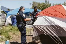  ?? Amy Osborne / Special to The Chronicle 2021 ?? Police forcibly move homeless residents from Dunphy Park to Marinship Park in Sausalito on June 29, 2021. Jeremy Portje was working in the area Nov. 30 when police arrested him.