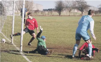  ??  ?? Logan watches on as his back-post header creeps in (above), while Seamer defend a ball into the box (below)