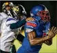  ?? RICHARD GRAULICH / THE PALM BEACH POST ?? Pahokee junior Jatarie Washington tries running away from Boynton Beach’s Tyier Lang.