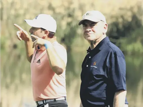  ??  ?? 0 Sergio Garcia, left, and former R&A chief executive Peter Dawson walk the Jumeirah Golf Estates course during yesterday’s Pro-am.