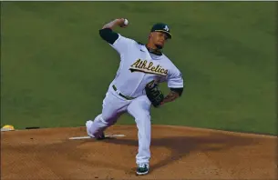 ??  ?? Oakland’s Frankie Montas delivers a pitch during Friday night’s season opener against the Angels.