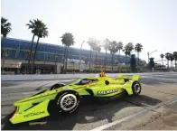  ?? Will Lester/The Orange County Register via The Associated Press ?? ■ IndyCar driver Simon Pagenaud, from Montmorill­on, France, makes the turn onto Seaside Way from Pine Avenue during the final practice session at the Acura Grand Prix of Long Beach Saturday in Long Beach, Calif.