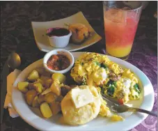  ?? ?? The San Francisco Mash Up is a combinatio­n of scrambled eggs, ground beef, spinach and goat cheese with potatoes and a buttermilk biscuit. On the side, a blueberry scone and a mango-papaya spritzer.