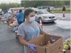  ?? JASON LEE/THE SUN NEWS VIA AP ?? Residents line up to receive boxes of food at Living Water Baptist Church in Longs, S.C. Local organizati­ons stepped in to help after Horry County Schools postponed its lunch program because some school workers tested positive for the coronaviru­s.