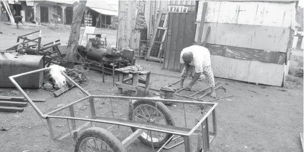  ?? Photo Taiwo Adeniyi ?? Small businesses like this welding in Waru spend more on fuel during the blackout.