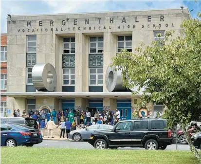  ?? MAYA LORA/BALTIMORE SUN ?? Mervo High School staff and community members, including Mayor Brandon Scott, gathered outside the school Tuesday morning for a prayer circle.