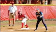  ?? MARK HUMPHREY ENTERPRISE-LEADER ?? Farmington coach Randy Osnes, shown coaching third base while Carley Antwine poises herself to race home against Harrison in an 8-1 victory on April 4, quietly achieved a milestone with his 500th career win April 1 over Conway. Osnes has been head...