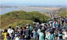  ?? PHOTO: AP ?? Visitors watch the North Korea side from the unificatio­n observator­y in Paju, South Korea, near the border with North Korea.