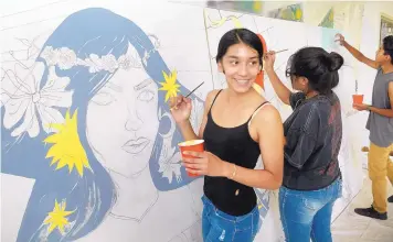  ?? GREG SORBER/JOURNAL ?? Savannah Fairbanks, 16, left, and Daryllen Ray, 16, paint a traveling mural at the Tamaya Wellness Center at Santa Ana Pueblo. The mural is the fifth in a project called Murals to End Gun Violence.