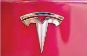  ?? [AP FILE PHOTO] ?? A Tesla emblem is seen on the back end of a Model S in the Tesla showroom in Santa Monica, Calif. On Thursday, Tesla shares have dropped back to near the level they were trading at before CEO Elon Musk tweeted Tuesday that he may take the company private.