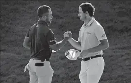  ?? Seth Wenig Associated Press ?? XANDER SCHAUFFELE, left, shakes hands with his good friend Patrick Cantlay. Schauffele holds a one-shot lead over Cantlay heading into the final round.