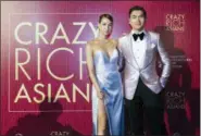  ??  ?? Actor Henry Golding and his wife, Liv Lo, pose as they arrive for the red carpet screening of the movie “Crazy Rich Asians” on Tuesday in Singapore.